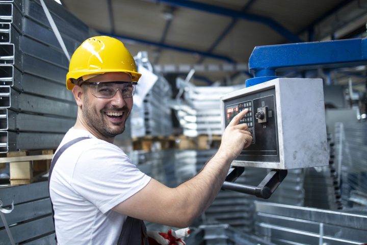 portrait-factory-worker-operating-industrial-machine-setting-parameters